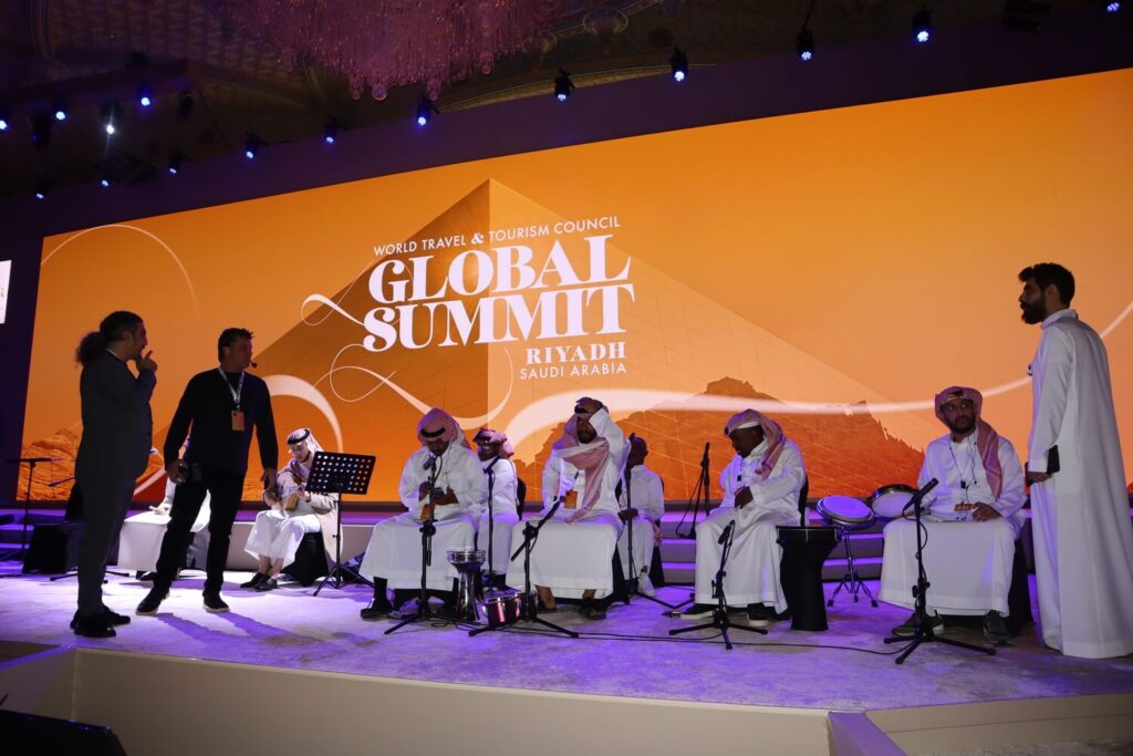 Traditional Saudi musicians preparing and performing on stage during the Global Summit in Riyadh